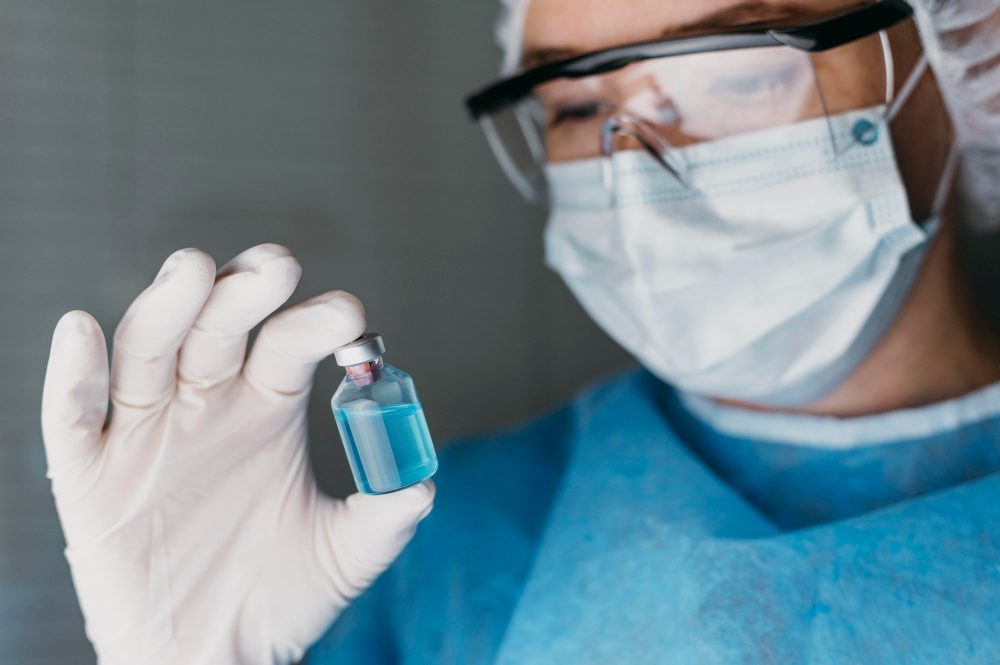Laboratory technician inspecting a vial